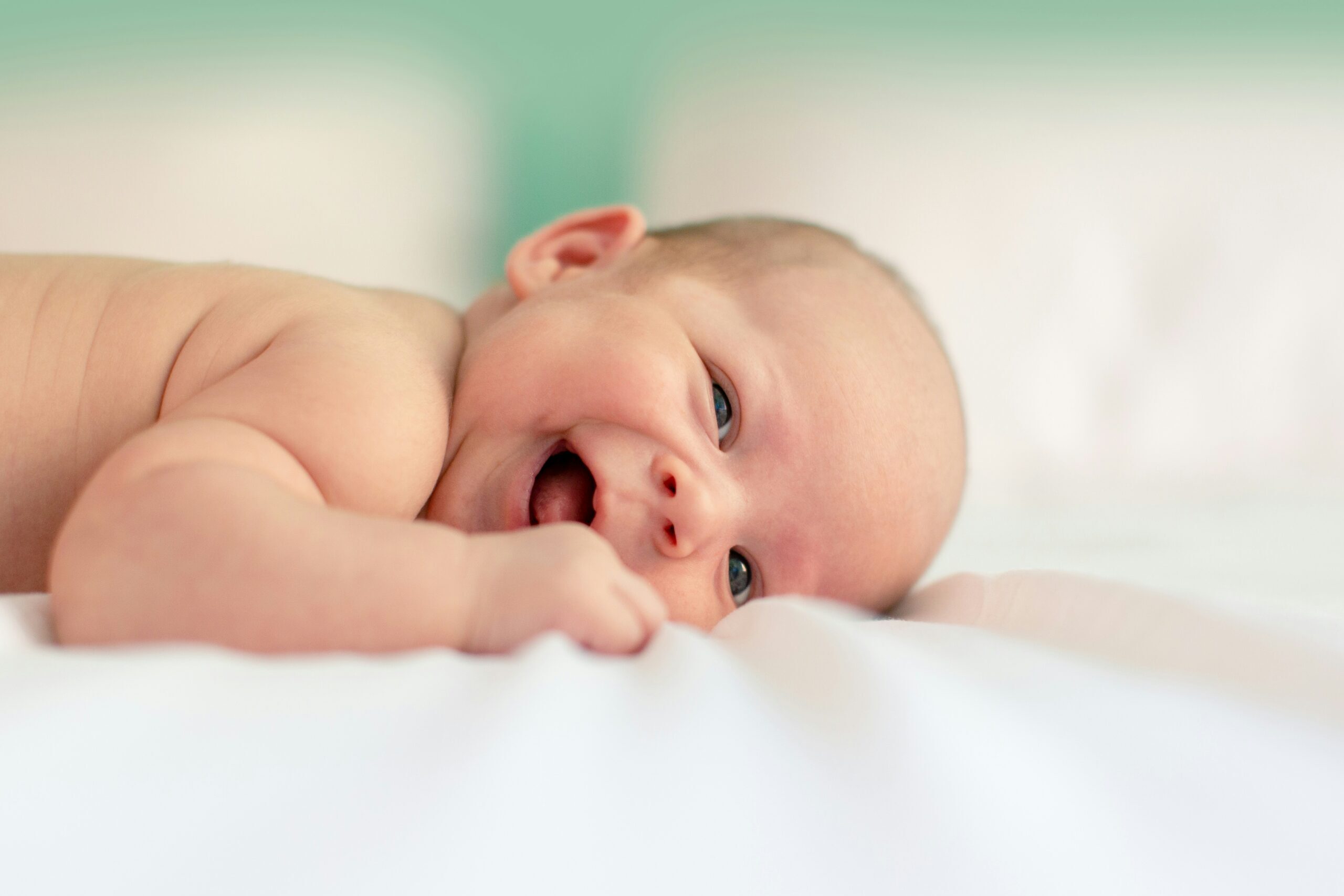 baby lying on fabric cloth